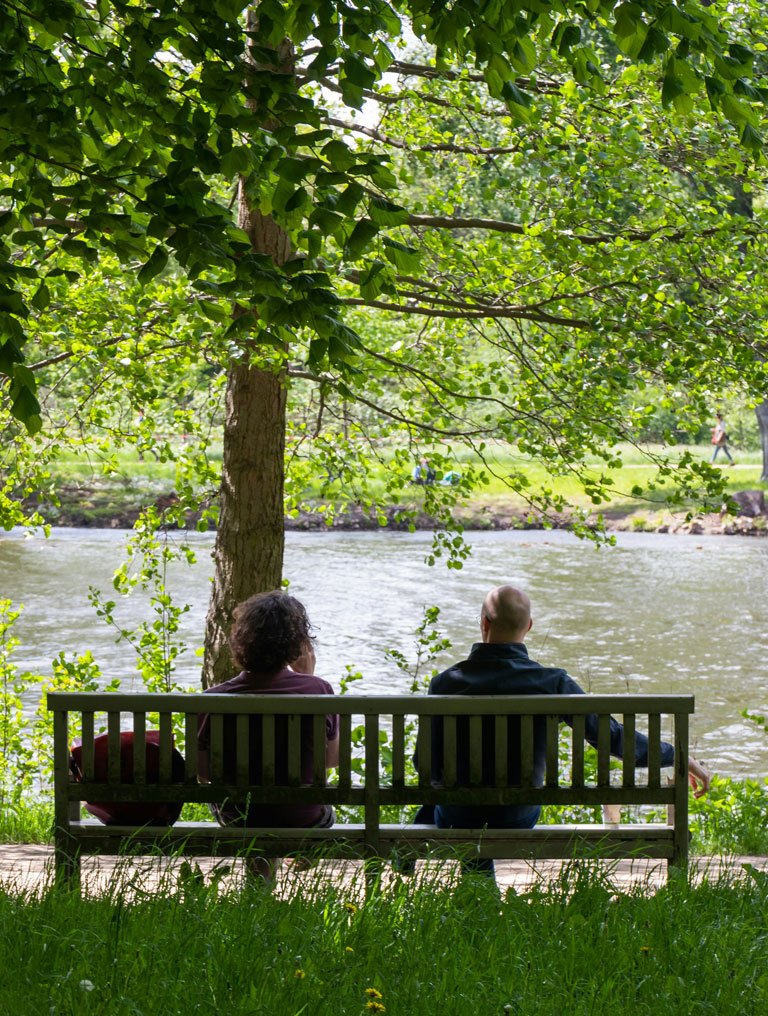 elderly couple sitting in a bench